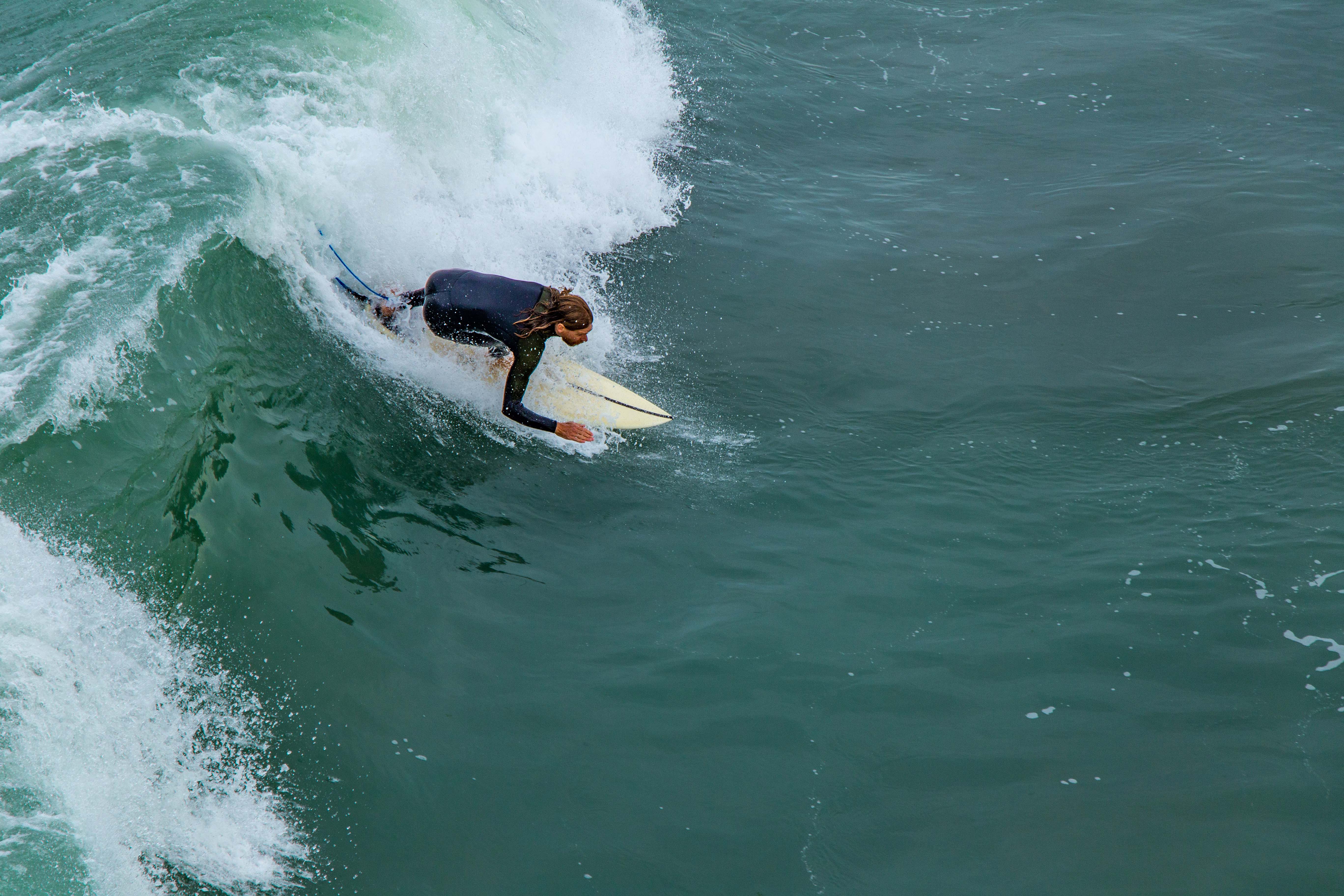 Surfer at New Brighton beach, Christchurch NZ